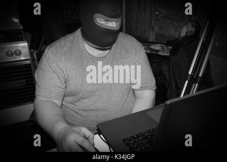 Terrorist working on his computer. Concept about international crisis, war, terrorism ,terrorist and bandit Stock Photo