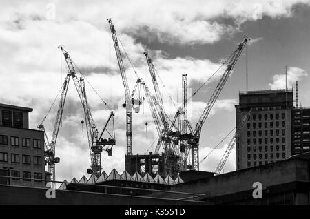 Tower cranes on the skyline at the partially built new Southbank Tower apartment block construction site, South Bank, Southwark, London SE1 Stock Photo