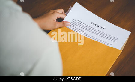 Women are opening an envelope document about signing a contract in business and sign contract concept,vintage style Stock Photo