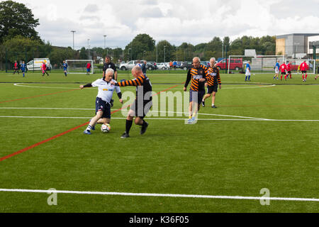 Heywood, Greater Manchester, UK. 1st Sep, 2017. Today saw the kick-off of the second season for the Greater Manchester Over 60s Walking Football league at Heywood Sports Village. David Mort, playing for Bolton Wanderers A, shows considerable body swerve against his Roach Dynamos opponent. Walking Football is one of the fastest growing areas of organised football in the UK, aimed at increasing health and fitness through physical activity in the over 50s, encouraged by football clubs, health professionals and the Football Association. Credit: Joseph Clemson/Alamy Live News Stock Photo