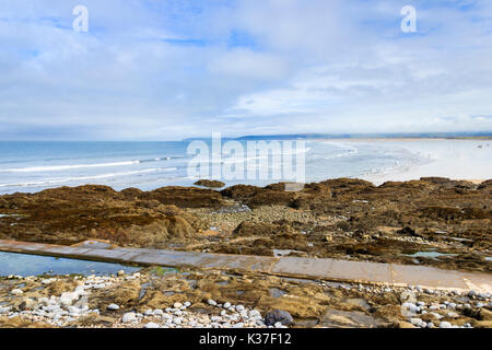 Victorian pipe on rocky beach at Westward Ho, Devon, England, UK Stock Photo