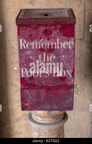 A Remember the Poors Box located at St. Bartholomews Hospital in London, UK.  Before the National Health Service, the sick were dependent on charity a Stock Photo