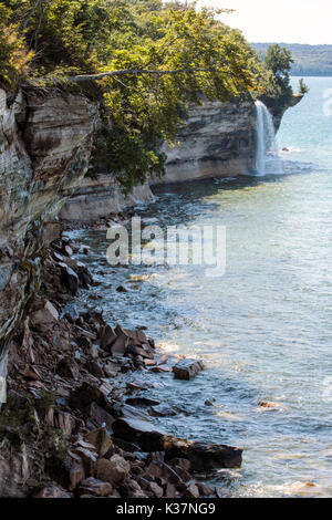Spray Falls cascades over Pictured Rocks National Lakeshore and empties into Lake Superior, in the Upper Peninsula of Michigan Stock Photo