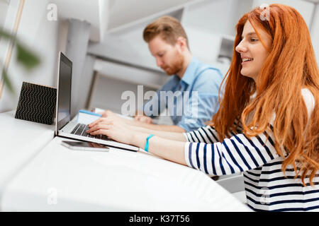 Colleagues working studying in white office Stock Photo