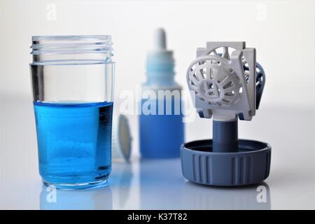 An image of eyedrops with a contact lens case (correction) Stock Photo