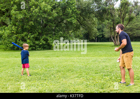 Happy father and his son playing baseball Stock Photo