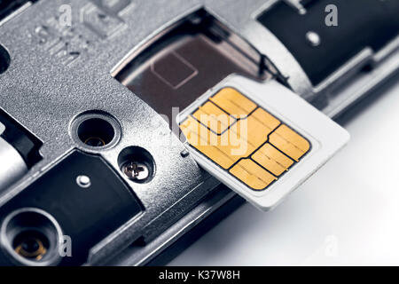 insert sim card in smart phone Stock Photo