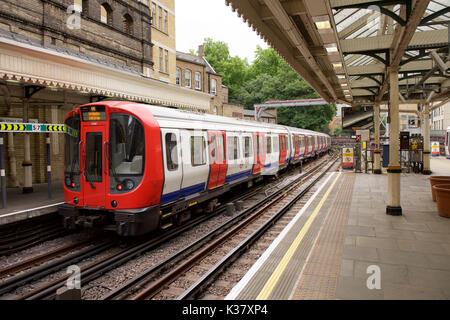 District Line train at High Street Kensington Underground station in London Stock Photo