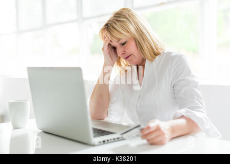 mature woman using laptop at home Stock Photo