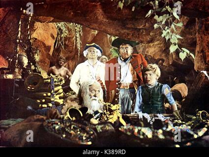 TREASURE ISLAND GEOFFREY WILKINSON as Ben Gunn (foreground), Walter Fitzgerald (back), ROBERT NEWTON as Long John Silver, BOBBY DRISCOLL as Jim Hawkins Stock Photo