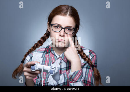 Nerd Woman with Braid Playing Videogames with a Joypad Stock Photo