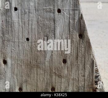 Old grey wood with dark screws showing Stock Photo