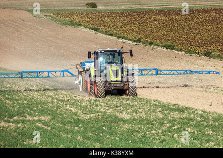 Tractor Claas Spraying crops field, Czech Republic Farmer Stock Photo
