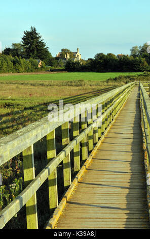 the walkways and old boathouse at newtown creek national trust, isle of wight showing fields and tidal estuary for birdwatching. hamstead creek. Stock Photo