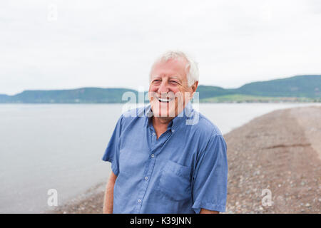 Senior Man at the beach having good time Stock Photo