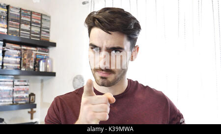 Confused or doubtful young man looking up Stock Photo