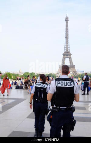 Armed French police patrol the streets of Paris and the Eiffel Tower in response to the terror alert in France, protecting tourist landmarks & sights Stock Photo