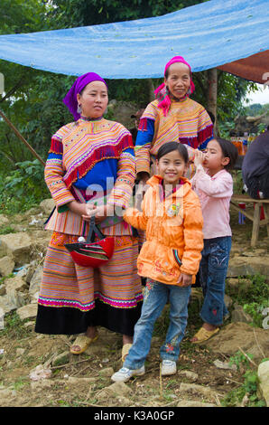 North Vietnamese women in colorful native clothing with children in Western garb at Bac Ha market on Oct 23, 2011 Stock Photo