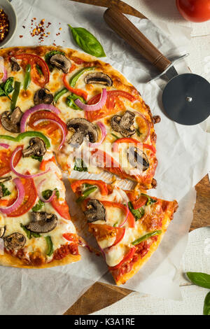 Homemade Veggie Pizza with Mushrooms Peppers Tomatoes and Spinach Stock Photo