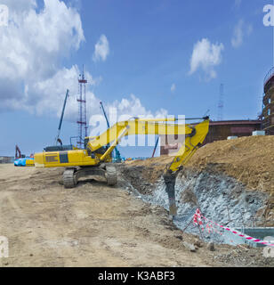 Hydraulic crusher for excavator at the site of rock destruction Stock Photo