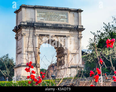 Titus Arch Red Flowers Roman Forum Rome Italy.  Stone arch was erected in 81 AD in honor of Emperor Vespasian and his son Titus for conqueiring Jerusa Stock Photo