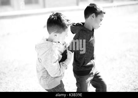 Two Boys Fighting In Playground Stock Photo