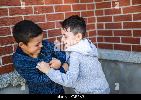 Two Boys Fighting In Playground Stock Photo