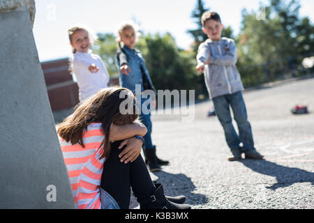Elementary Age Bullying in Schoolyard Stock Photo