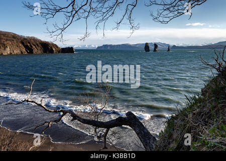 Beautiful Kamchatka Peninsula seascape: view of rocky islands in sea - Three Brothers Rocks in Avacha Bay (Avachinskaya Bay) in Pacific Ocean. Stock Photo