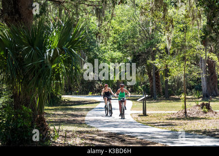 Georgia,Jekyll Island,barrier island,bicycle path,cyclist,adult adults woman women female lady,friends,biking,riding,path,visitors travel traveling to Stock Photo