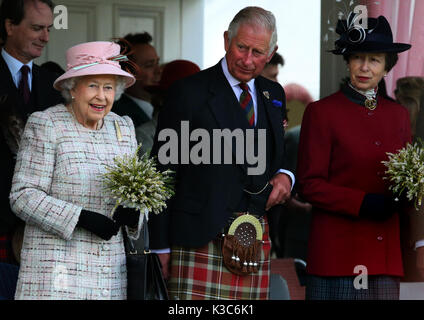 Queen Elizabeth II, the Prince of Wales, also known as the Duke of Rothesay in Scotland, and the Princess Royal, attend the Braemar Royal Highland Gathering at the Princess Royal and Duke of Fife Memorial Park, Braemar. Stock Photo