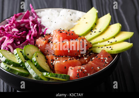 Raw Organic Ahi Tuna Poke Bowl with Rice and Veggies close-up on the table. Horizontal Stock Photo