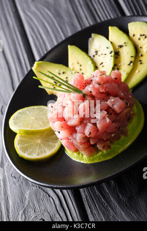 tartare of tuna with avocado, wasabi and lime closeup on a plate. vertical Stock Photo