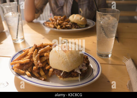 Pulled pork Barbecue Sandwich with garlic fries at Meat Restaurant in Strathcona, Edmonton, Canada. Stock Photo