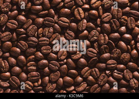 Roasted coffee beans on a flat background. Stock Photo