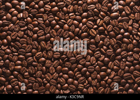 Roasted coffee beans on a flat background. Stock Photo