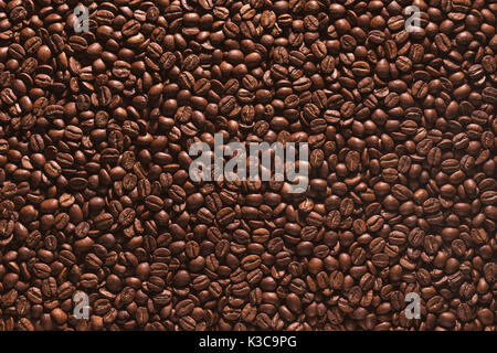 Roasted coffee beans on a flat background. Stock Photo