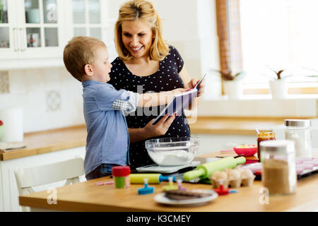 Beautiful child and mother baking Stock Photo