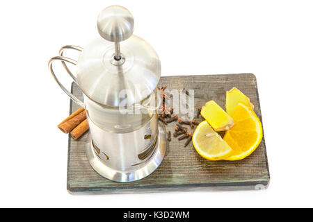 Glass teapot with green tea. Ginger tea with lemon and cinnamon on a wooden board Stock Photo