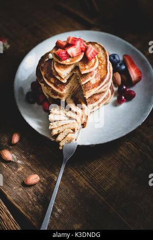 Whole wheat oat pancakes with berries on a plate Stock Photo