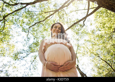 Young beautiful pregnant woman with long hair Stock Photo