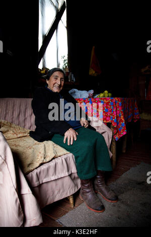 Chile, Araucania, Curacautin, Mapuche, woman, sofa, sit, Stock Photo