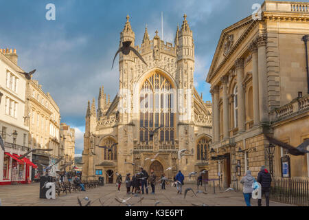 Bath UK Abbey, view of the west end of Bath Abbey in the centre of the city with the Pump Room and entrance to the Roman Baths on the right, England. Stock Photo