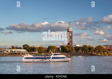 Holiday ship on the Rhine River in front of the old fair trade tower, Cologne, North Rhine-Westphalia, Germany Stock Photo