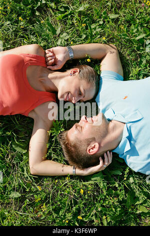 Young couple lies in a meadow Stock Photo