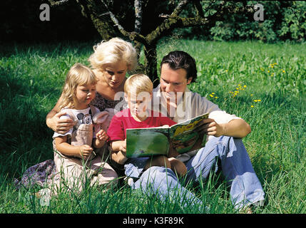 Young family on a meadow Stock Photo