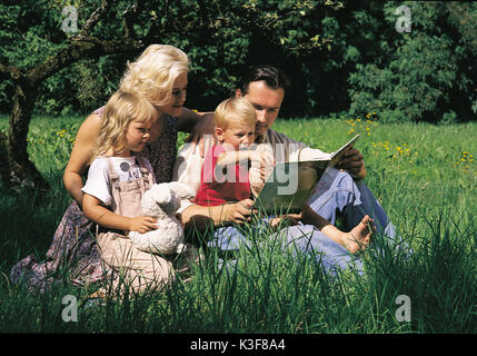 Young family on meadow Stock Photo