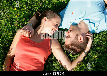 Young couple lies in a meadow Stock Photo
