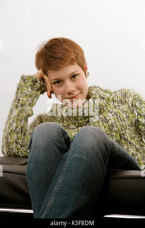 Young woman steady herself on her hand and smiles Stock Photo