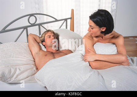 Young couple talks in the bed Stock Photo